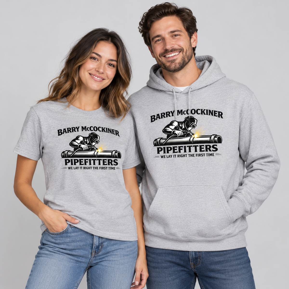 Woman and man wearing gray Barry McCockiner Pipefitters graphic T-shirt and hoodie