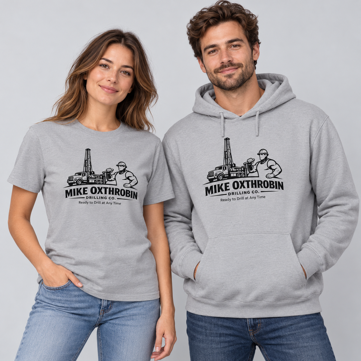 Woman and man wearing gray Mike Oxthrobin drilling company graphic T-shirt and hoodie